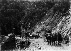 Two horse drawn coaches travelling through the Otira Gorge