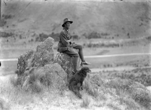 Cyril McCusker in the uniform of a mounted rifleman, with a dog, at Taylor Pass, Marlborough