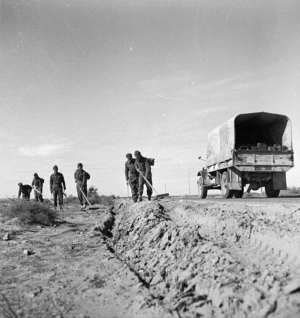 Paton, H fl 1942 (Photographer) : New Zealand Engineers search for German and Italian mines on the roadside in Tripoli, Libya, during the 8th Army advance