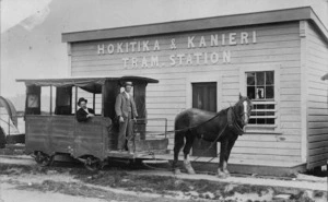 Hokitika & Kanieri tram station with horse drawn tram, operator and passenger alongside