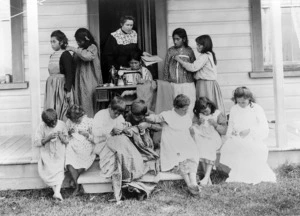 Female teacher taking a outdoor sewing class for children