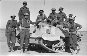 Members of a World War 2, North Island Battalion reconnaissance party, alongside a Bren carrier, in Libya
