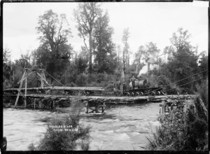 Railway locomotive with logs, on a bridge over the Arnold River, at Kokiri