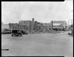 1931 Hawke's Bay earthquake, unidentified street location, damaged building with general store and church in the back ground