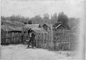 Unidentified man outside a Maori pa at Te Kumi