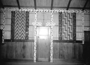 Maori carving, kowhaiwhai, and tukutuku work inside an unidentified building