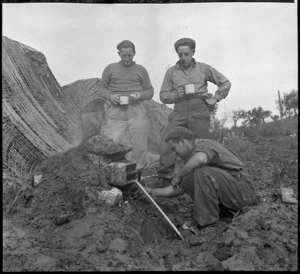 New Zealand troops, and their improvised fireplace, Italy, during World War 2