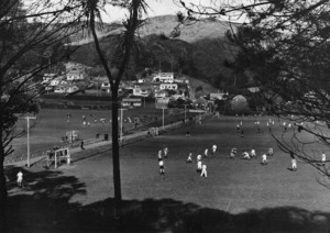Boyer, Charles P S, fl 1920-1940 (Photographer) : Sports ground and houses, Karori, Wellington, with hockey games in progress