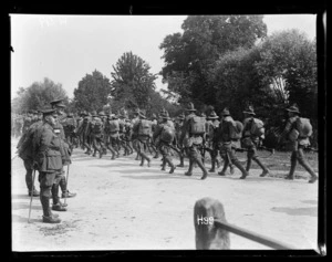 New Zealand troops on a route march being inspected by General Godley