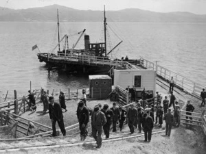 Group alongside a wharf, arriving on Somes Island