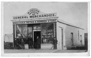 Men and boys standing outside W Geisow's store, Invercargill - Photograph taken by James Brown