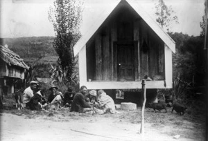 Maori group alongside a storehouse