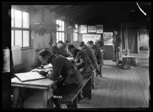 New Zealand soldiers work on poster illustrations, England