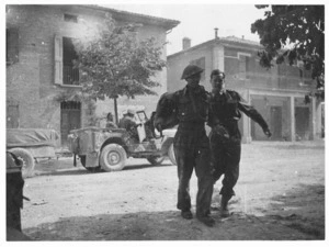 Wounded New Zealander being assisted into 27 Battalion Regimental Aid Post at Villa Fontana, Italy