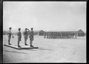 Members of the New Zealand Artillery on parade, marching past Brigadier C E Weir in Maadi, Egypt, during World War 2 - Photograph taken by George Kaye