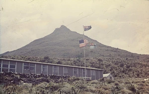 The hostel at Beeman Cove, with flags flying for the arrival of a United States ship