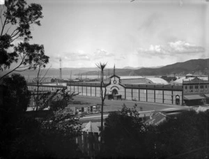 View in the vicinity of Queens Wharf, Wellington, including the building for the 1885 New Zealand Industrial Exibition