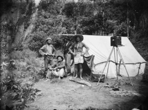 Four men and a camera at a campsite