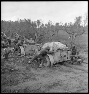 New Zealand artillerymen manhandling guns in heavy mud on the Sangro River front - Photograph taken by George Kaye