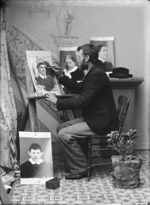 Edward George Child (retouching photographs?) in his studio at Ohingaiti