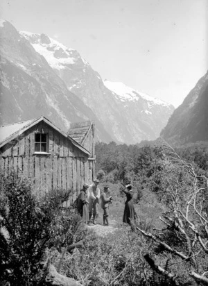 Members of the Gifford party outside a hut