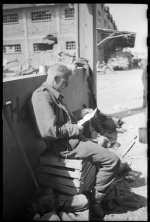 Soldier Andy Willis (Invercargill) reading some of his mail, Massa Lombarda area, Italy