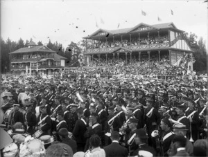 Crowd at the Wanganui racecourse, including brass band members