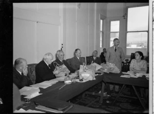 Mr A W Davis presenting gift of a kete, made by a member of the Maori Women's Health League, to Peter Fraser, Prime Minister of New Zealand