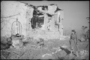 School mistress by the remains of the village school at Celle, Italy, during World War 2