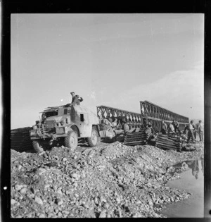 Tractor and gun of New Zealand Artillery crossing a newly finished bridge over the Sangro River, Italy, during World War II - Photograph taken by George Kaye