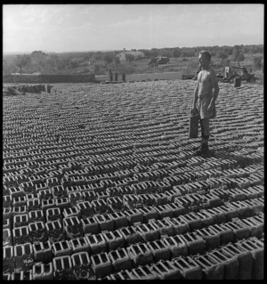 New Zealand soldier and petrol cans, Taranto, Italy, during World War 2