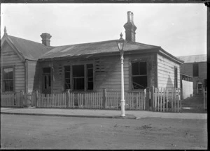 House after a fire, showing damage to walls, windows and roof, at Petone.