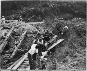 Car crossing on a makeshift bridge during the first motor trip from Wellington to Auckland - Photograph taken by E Gillings