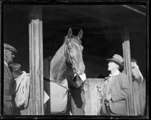 Racehorse Phar Lap, with handler/jockey Reginald James Mackie, at Hugh Telford's stables, Trentham, Upper Hutt