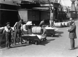 Wellington wharf workers moving meat carcasses and barrels of tallow