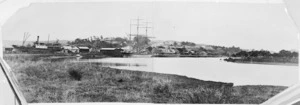 View of Helensville and the river. Ships SS Aotea, and Hazel Craig moored at the wharf.