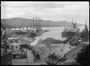 Harbour scene, probably at Port Chalmers, with several ships berthed at the wharves including the steel 4 masted barque "Olivebank"