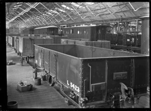 Interior view of a workshop at the Hillside Railway Workshops, Dunedin, showing wagons and carriages.