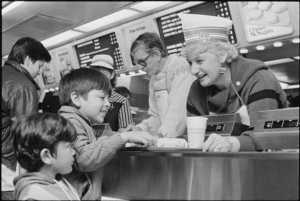 Kapiti Member of Parliament and Consumer Affairs Minister Margaret Shields serving her nephews Alex and Antony Ibrahim at McDonalds restaurant, Porirua - Photograph taken by Ian Mackley