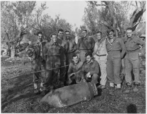 New Zealand soldiers grouped about an undetonated enemy bomb - Photograph taken by George Frederick Kaye