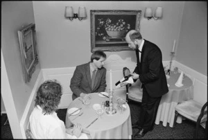 Philip Temple, Orsini's proprietor, presenting a bottle of wine to a customer - Photograph taken by Ray Pigney