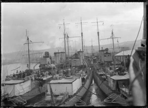 View of the stern of three American warships moored at Dunedin Wharf.