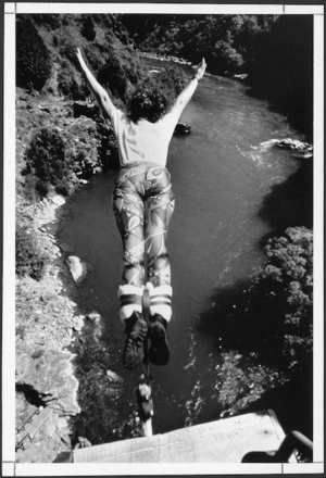 Woman doing a A J Hackett bungy jump at Skippers Canyon, Otago