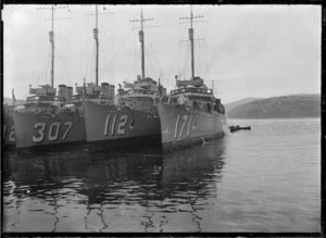 View of the prows of three American warships moored at Dunedin Wharf.