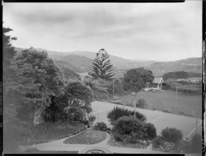 Tennis court and small building, with cemetery in background, Homewood, Karori, Wellington