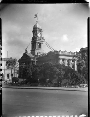 Wellington Town Hall clock tower with New Zealand flag and British flag