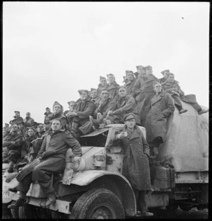 New Zealand soldiers watching a rugby game played outside Tripoli during World War 2 - Photograph taken by Harold Gear Paton