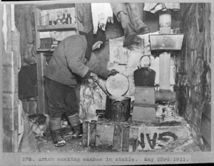 Anton Omelchenko cooking mash in the stable during the British Antarctic Expedition of 1911-1913