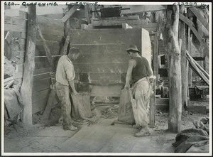 Men bagging crushed limestone at a quarry in Hicks Bay