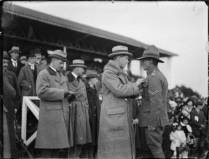 Edward, Prince of Wales, during his tour of New Zealand, presenting a decoration to a soldier